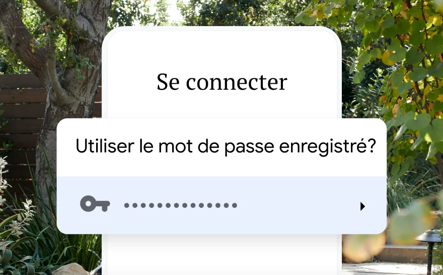 Une page de connexion pour la réservation d'un voyage demande l'utilisation d'un mot de passe enregistré. En arrière-plan, un paysage de nature.